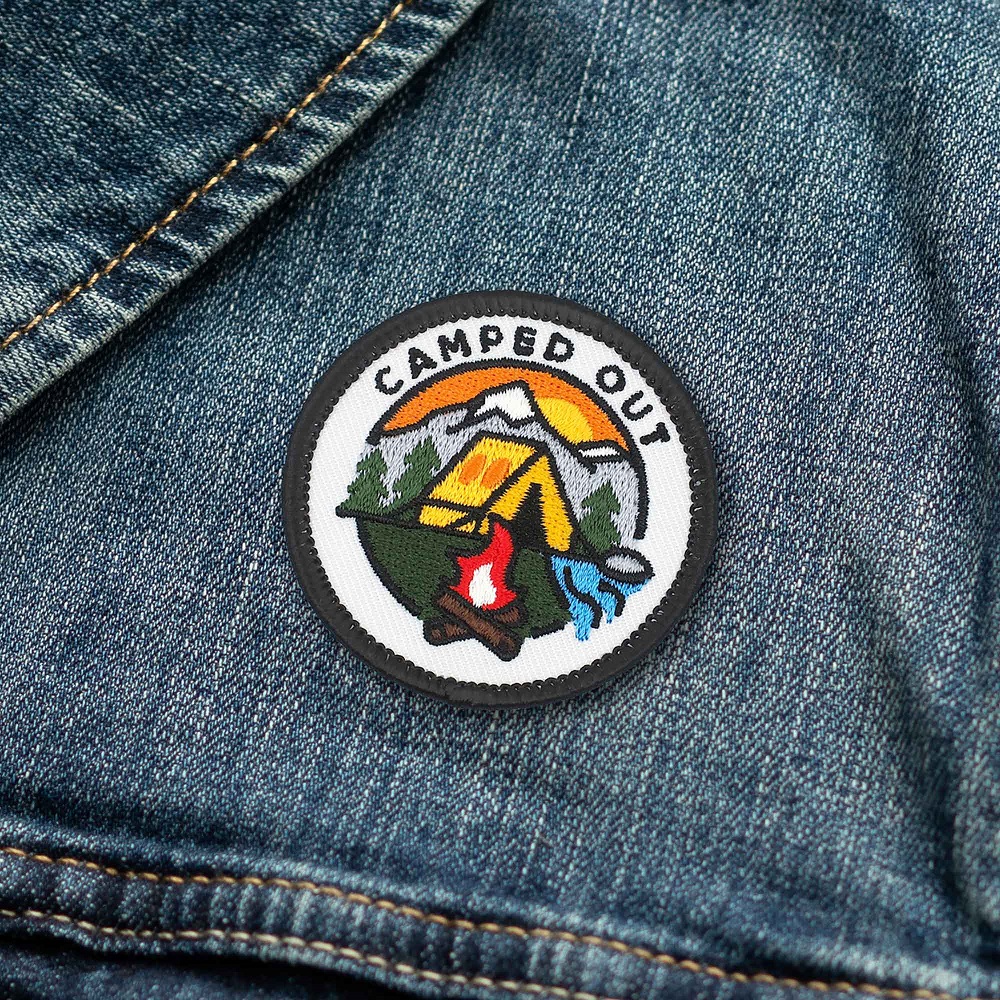 camped-out-holding-merit-badge-patch