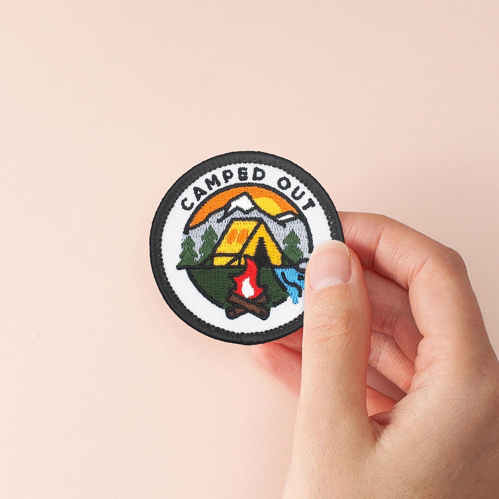 camped-out-holding-merit-badge-patch